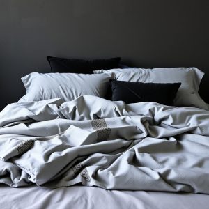 Layered Grey Bedding with Black Pillows