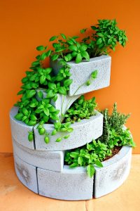 Image Prompt:
Outdoor garden steps made of stacked concrete blocks, with small flowers and green plants growing from block holes along the sides.